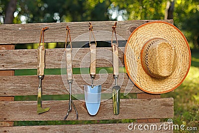 Garden tools on board fence Stock Photo