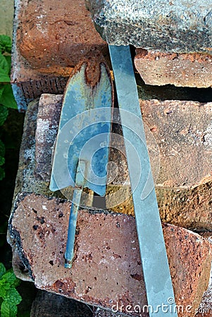 Garden tools vintage spade shovel resting on antique bricks Stock Photo