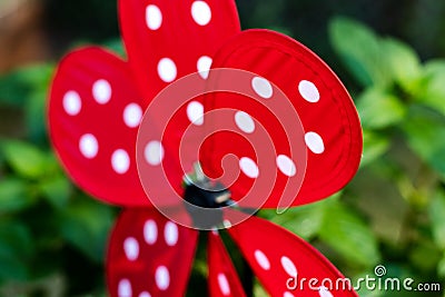 Garden whirligig abstract red with white ladybug dots Stock Photo