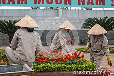 Gardeners tending Salvia flower beds at Ho Chi Minh Tomb in Hanoi, Vietnam Editorial Stock Photo
