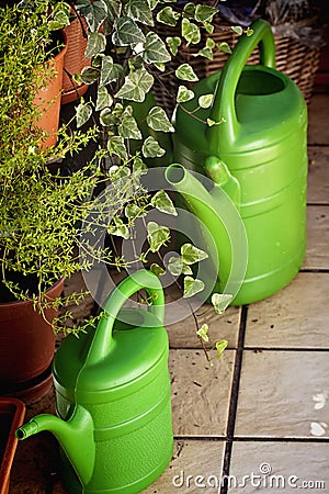 Gardening on the balcony, watering cans Stock Photo