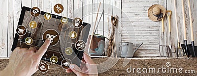 Gardening equipment e-commerce concept, online shopping on digital tablet, hand pointing and touch screen with garden tools icons Stock Photo