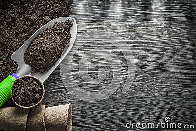 Gardening peat glasses soil spade on wooden board Stock Photo