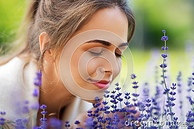 Close up of woman smelling lavender flowers Stock Photo