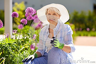 Senior woman with garden pruner and flowers Stock Photo