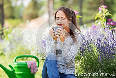Woman drinking tea or coffee at summer garden Stock Photo