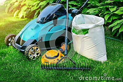 Gardening tools and lawn care equipment on green grass Stock Photo