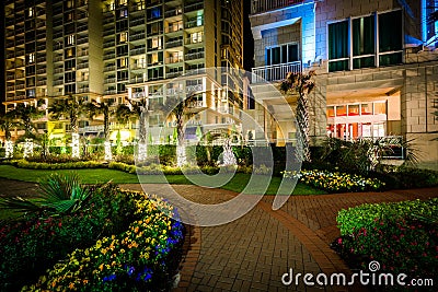 Gardens along a walkway and highrise hotels at night, in Virginia Beach, Virginia. Editorial Stock Photo