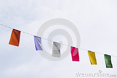Garland with colorful pennants hanging on a city street Stock Photo