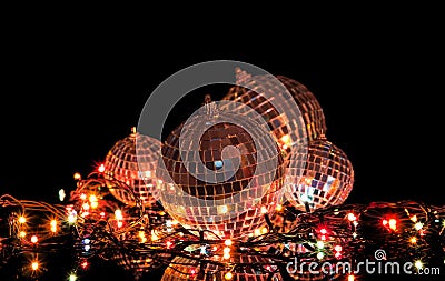 Garland lights and set of mirrored balls on black background Stock Photo
