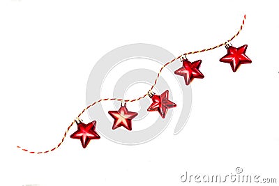 A garland of red Christmas toys in the shape of stars Stock Photo