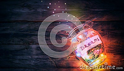 Garlands of colored lights in glass jar with dreams Stock Photo