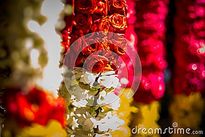 Garlands of red and yellow flowers. Flower stall selling garlands for temple and marriage functions. Selling flowers Garlands on Stock Photo