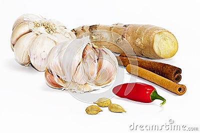 Garlic bulbs, chili pepper, ginger, green cardamom pods and cinnamon Stock Photo