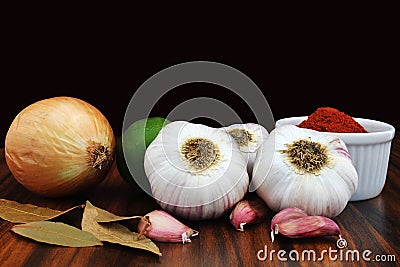 Garlic bulbs, onion, lemon and spices. Brazilian seasonings with black background Stock Photo