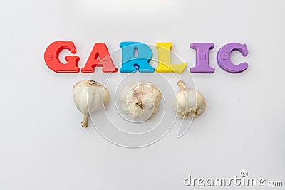 Garlic bulbs with garlic tittle on white isolated background with selective focus Stock Photo