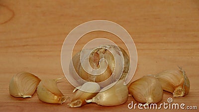 Garlic cloves on rustic in wooden table. Fresh peeled garlics and bulbs. Stock Photo