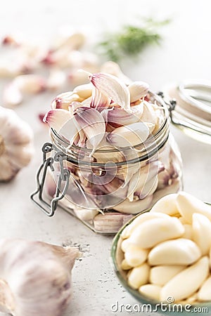 Garlic concept consisting of a jar full of lovely aromatic garlic cloves Stock Photo