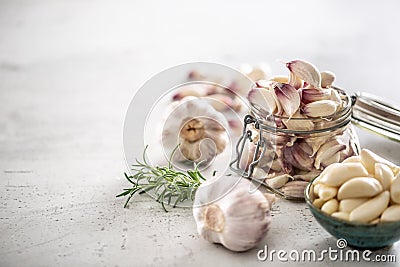 Garlic concept consisting of a jar full of lovely aromatic garlic cloves Stock Photo