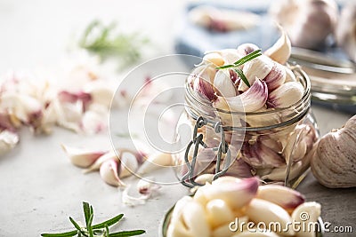 Garlic concept consisting of a jar full of lovely aromatic garlic cloves Stock Photo