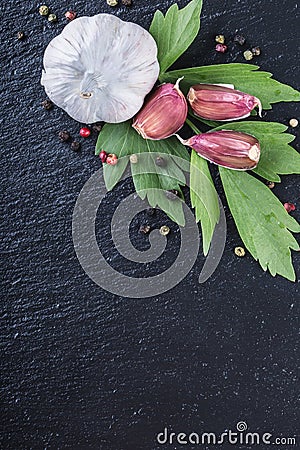 Garlic. Fresh Garlic. Cloves of garlic with parsley herb top leaves and pepper four colours Stock Photo