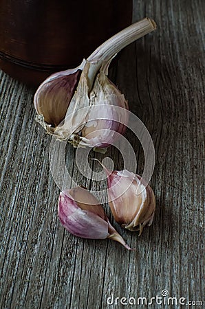 Garlic and garlic cloves on wooden table. rustic still life Stock Photo