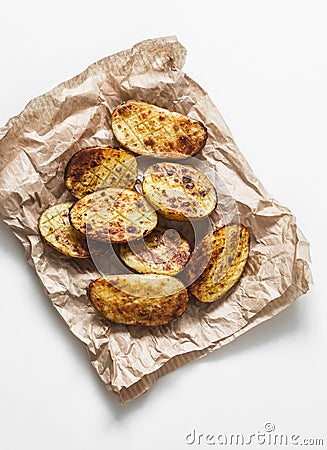 Garlic grilled potatoes baked on a light background top view Stock Photo