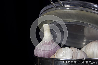 Garlic in a metal container Stock Photo