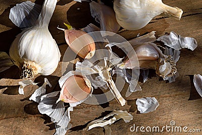 Garlic and onion on wooden table, detail of whole onion and crushed garlic Stock Photo