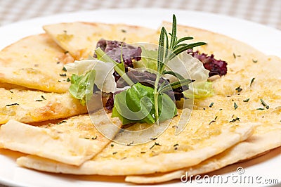 Garlic pita bread pizza with salad on top Stock Photo