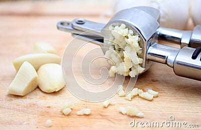 Garlic Press with Fresh Garlic Stock Photo