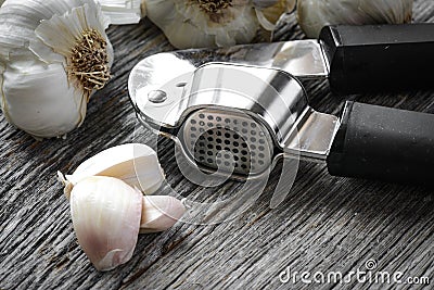 Garlic Press and Garlic Bulb Close Up Stock Photo