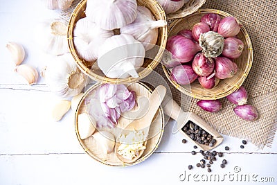 Garlic,shallot,Black pepper, fresh garlic, garlic clove, garlic bulb and Onion in a wooden basket on white wooden table, A herb Stock Photo