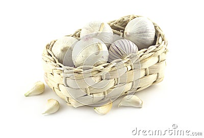 Garlic in wicker basket isolated on white Stock Photo