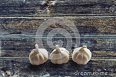 Garlic on wood surface. Stock Photo