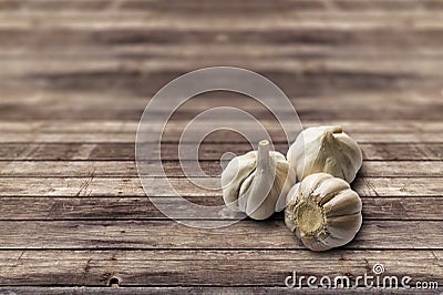 Garlic on wood surface. Stock Photo