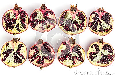 Garnet fruits cut on two isolated on white background top view. Halves of pomegranate fruits close up. Fresh, ripe garnets. Stock Photo