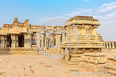 Garuda stone chariot and Vitthala temple gopuram, Hampi Stock Photo