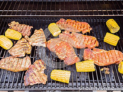 A gas barbeque grill with meat on Stock Photo