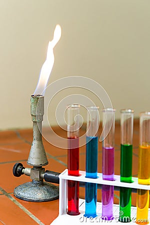 Gas burner with colored test tubes Stock Photo