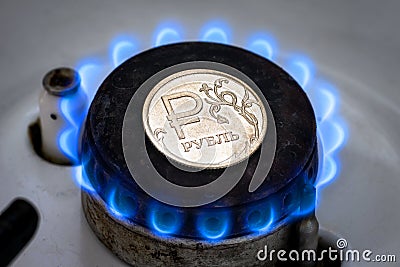 Gas burner and ruble coin, Russian money on home gas stove Stock Photo