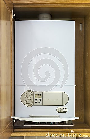 Gas central heating condensing boiler fitted inside a cabinet Stock Photo