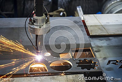 The gas cutting machine cutting the metal plate with the sparkling light. Stock Photo