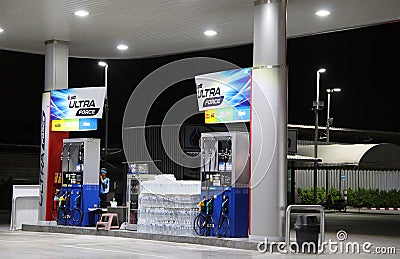 Gas dispenser of PTT gas station in Thailand on dark night. Editorial Stock Photo