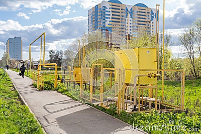 Gas distribution complex for supplying homes and businesses with valves and shut-off equipment in closed yellow boxes and pipes Editorial Stock Photo