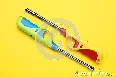 Gas lighters on yellow background, flat lay Stock Photo