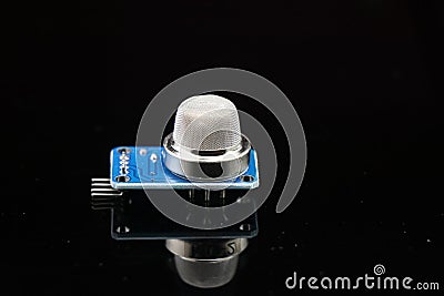 Gas sensor for arduino projects isolated on reflective black glass background, MQ2 gas sensor for gas leakage sensing Stock Photo