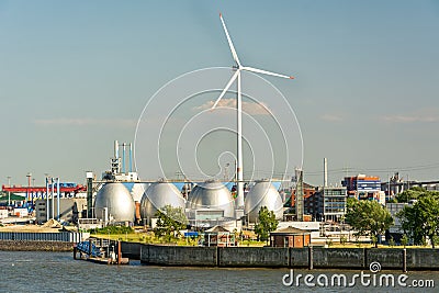 Gas storage reservoir and large wind turbine in the harbour area in Hamburg, Germany Stock Photo