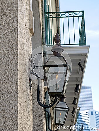 A gas street lamp with a finial atop adorns an old building in New Orleans Editorial Stock Photo