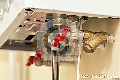 Gas water heater boiler for home heating, bottom view. Installation, connection and maintenance concept Stock Photo